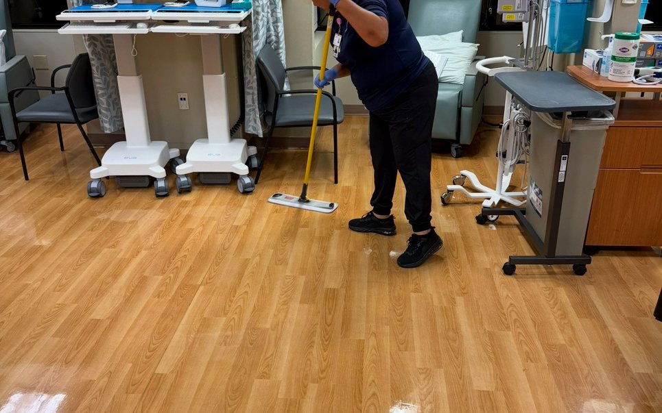 UFG team member operating commercial floor equipment